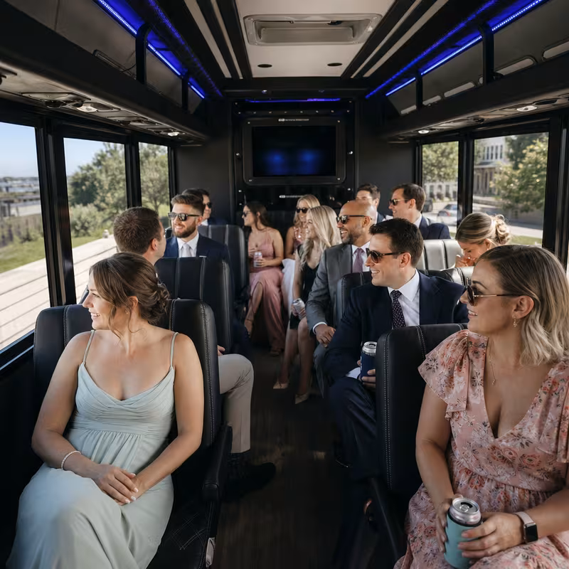 Wedding guests seated inside a New Orleans party bus