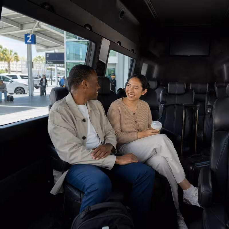 Passengers loading luggage while boarding an New Orleans group shuttle