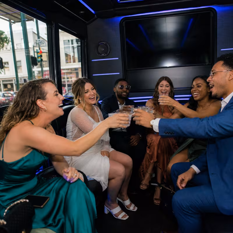 Party bus interior with wraparound leather seating and LED lighting in New Orleans