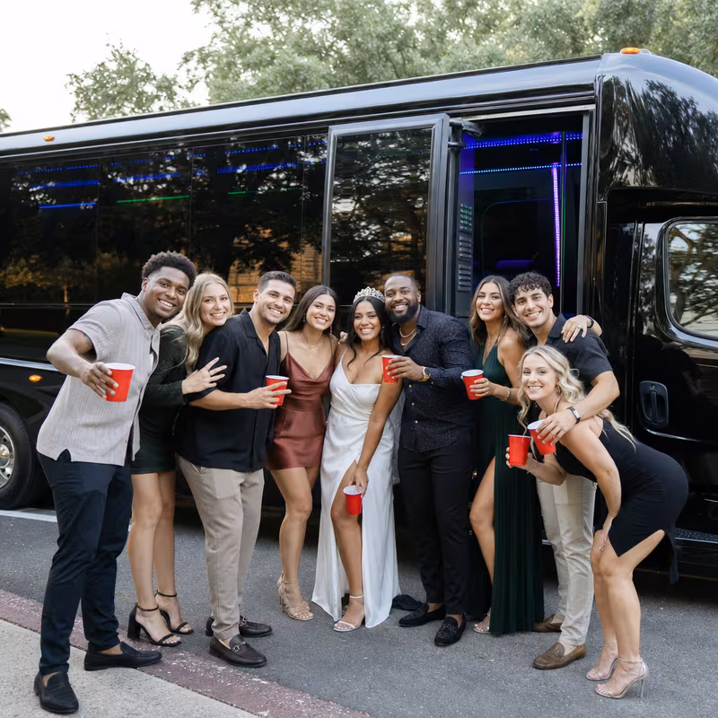 Group boarding a white charter bus for Birthday Transportation transportation in New Orleans