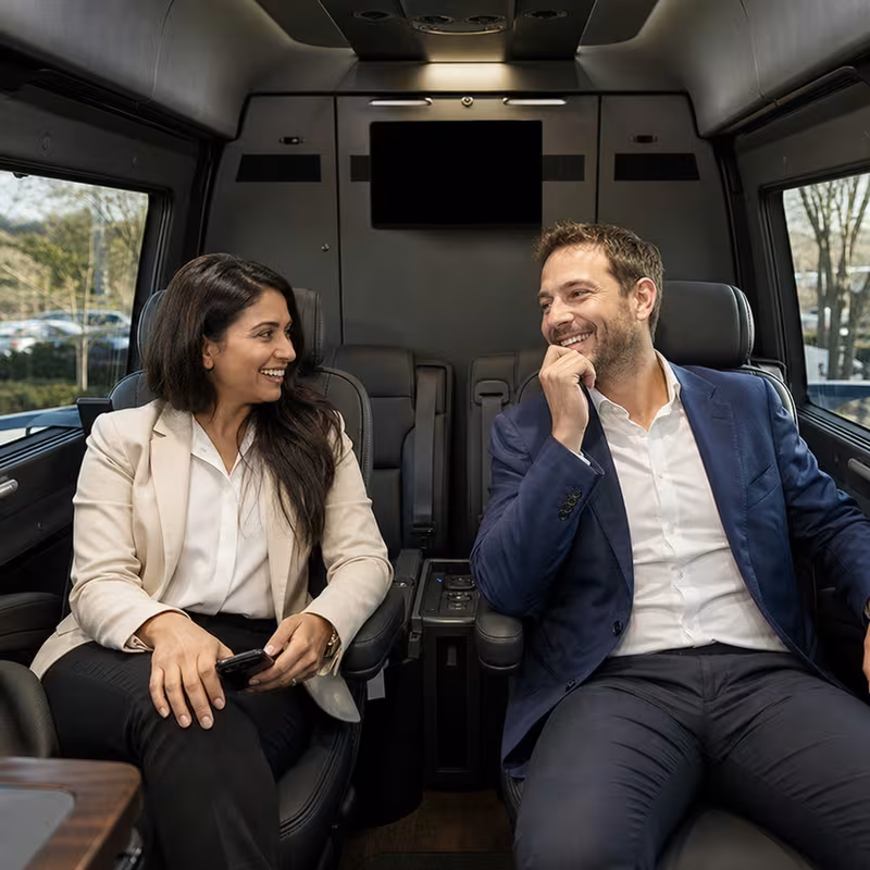 Group boarding a white charter bus for Corporate Transportation transportation in New Orleans