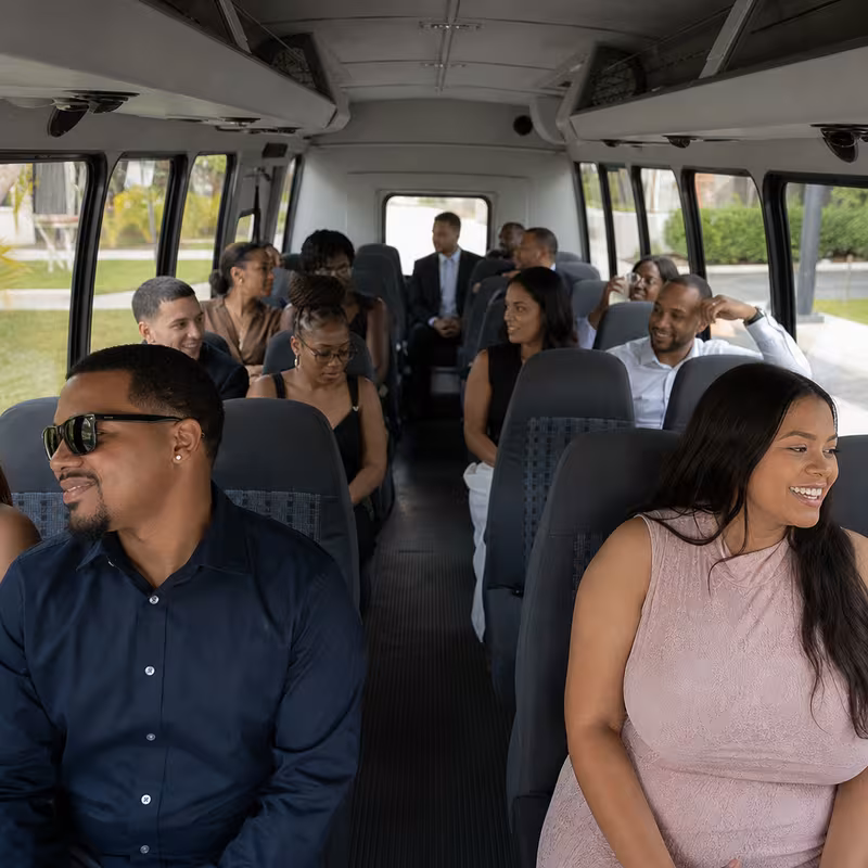 Group boarding a white charter bus for Private Event Transportation transportation in New Orleans