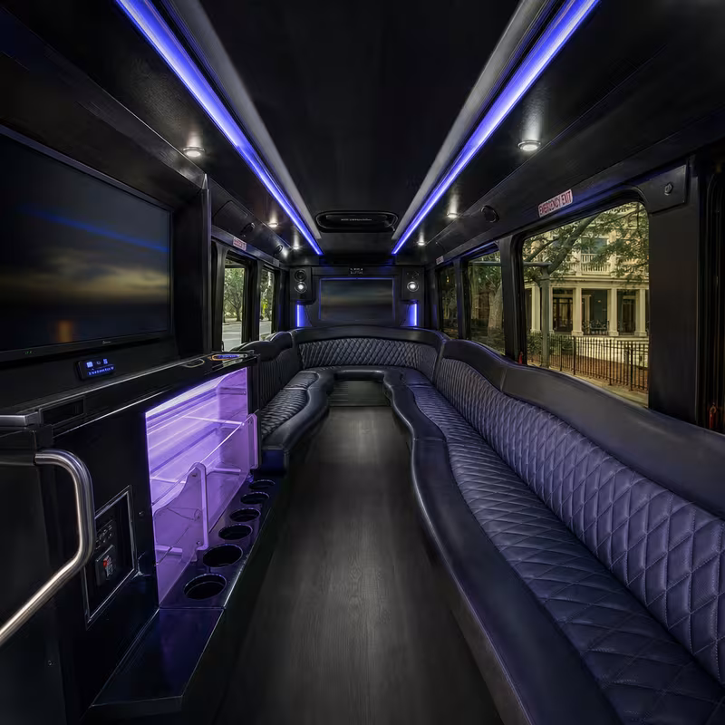 Party bus interior with wraparound leather seating and LED lighting in New Orleans
