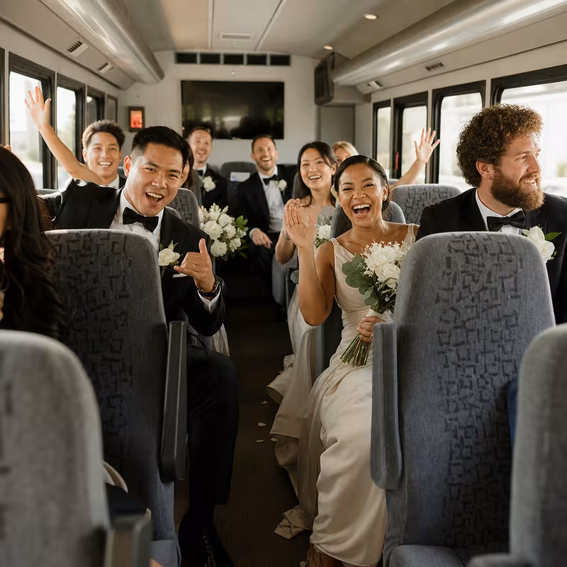Group boarding a white charter bus for Wedding Transportation transportation in New Orleans